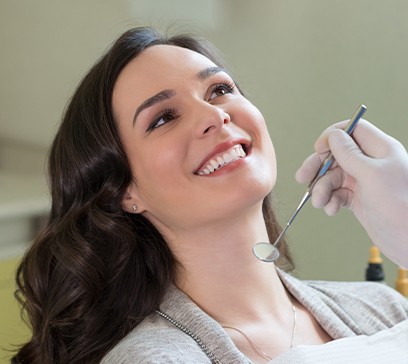 Woman smiling during periodontal treatment