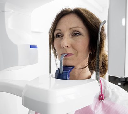 Woman receiving 3 D C T cone beam x-ray scans