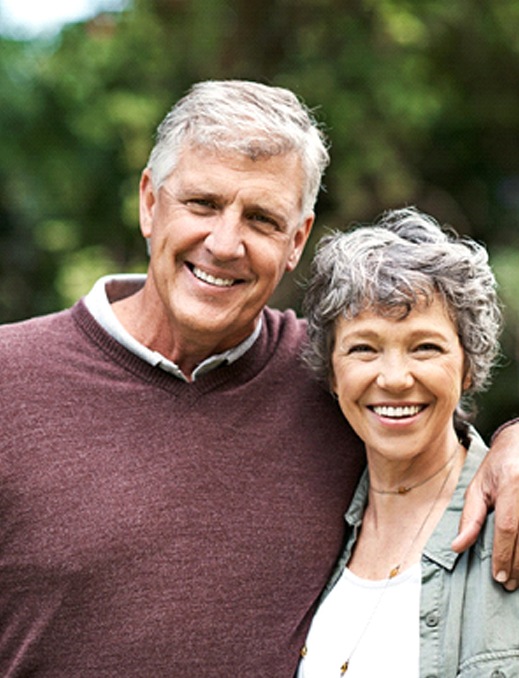 Older couple with All-on-4 in Bethel Park smiling outside