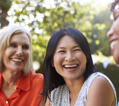 Woman with beautiful smile after dental implant tooth replacement