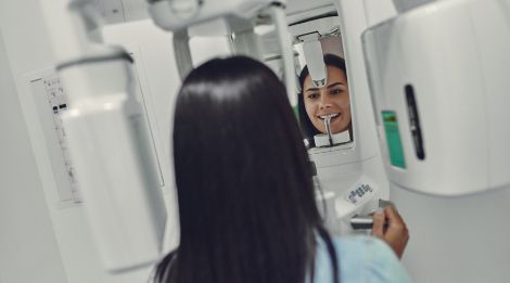 Woman receiving 3 D C T cone beam x-ray scans