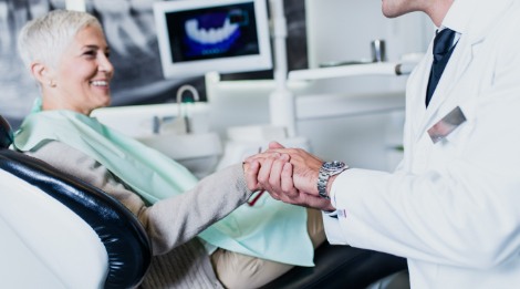Woman shaking hands with periodontist