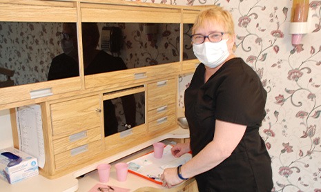 Periodontal team member behind reception desk