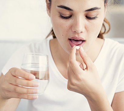 Woman taking oral conscious dental sedation pill