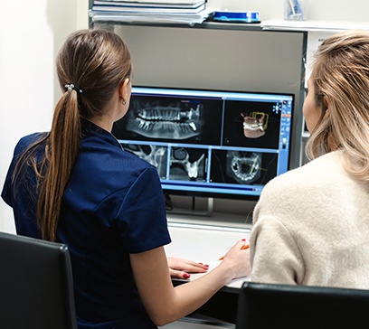 Dental team members looking at C T cone beam images